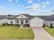 Charming single-story home with manicured lawn, stone accents, and a paved driveway at 6627 Ridgemont Rd, Lakeland, FL 33813