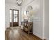 Stylish foyer featuring wood-look tile, shiplap accent wall, and a rustic console table at 6627 Ridgemont Rd, Lakeland, FL 33813