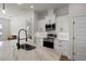 Kitchen featuring modern white cabinetry, stainless steel appliances and a large center island at 6627 Ridgemont Rd, Lakeland, FL 33813