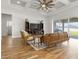 Open-concept living room with a coffered ceiling, leather couch, and outdoor access at 6627 Ridgemont Rd, Lakeland, FL 33813