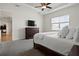 Bright main bedroom boasts large bed, wood dresser, and abundant natural light from large window at 6627 Ridgemont Rd, Lakeland, FL 33813