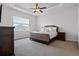 Main bedroom features a trey ceiling, neutral carpet, and a large window for natural light at 6627 Ridgemont Rd, Lakeland, FL 33813