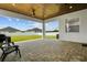 Spacious covered patio boasts stone pavers, a ceiling fan, and views of the fenced backyard at 6627 Ridgemont Rd, Lakeland, FL 33813