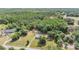 Scenic aerial view showcasing a home nestled in a lush, green, forested landscape at 7011 Tall Pine Rd, Polk City, FL 33868
