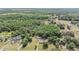 Broad aerial shot of a property surrounded by dense woods, providing a sense of privacy at 7011 Tall Pine Rd, Polk City, FL 33868