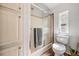 Bathroom featuring a shower with sliding glass door and a toilet under the window at 7011 Tall Pine Rd, Polk City, FL 33868
