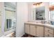 Bright bathroom features a shower, vanity with cabinets, and a large mirror at 7011 Tall Pine Rd, Polk City, FL 33868