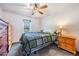 Cozy bedroom with a ceiling fan, a quaint window, and matching nightstand and dresser at 7011 Tall Pine Rd, Polk City, FL 33868