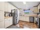 Well-lit kitchen with stainless steel appliances, white cabinetry, and ample countertop space at 7011 Tall Pine Rd, Polk City, FL 33868