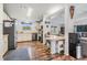Bright kitchen with stainless appliances, and a breakfast bar, seamlessly connected to the living space at 7011 Tall Pine Rd, Polk City, FL 33868
