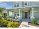 Inviting front porch with comfortable seating, a 'welcome' sign, and beautiful landscaping at 871 Fillmore Ct, Davenport, FL 33837