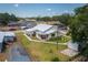 Aerial view of a single-Gathering home with a well-kept lawn and detached garage at 101 S Cleveland Ave, Fort Meade, FL 33841