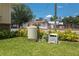 Lush backyard with green lawn, well-kept landscaping, and external mechanicals at 101 S Cleveland Ave, Fort Meade, FL 33841