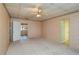 Spacious bedroom with neutral carpet, ceiling fan, and decorative wallpaper at 101 S Cleveland Ave, Fort Meade, FL 33841