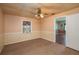 Bedroom with window, carpet, decorative wallpaper and ceiling fan at 101 S Cleveland Ave, Fort Meade, FL 33841