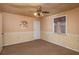 Bedroom with ceiling fan, window, and carpet with decorative wallpaper at 101 S Cleveland Ave, Fort Meade, FL 33841