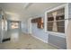 A bright bonus room with wood paneling, white trim, and natural light from multiple windows at 101 S Cleveland Ave, Fort Meade, FL 33841