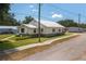 Home exterior features a well-kept lawn, landscaped yard, and sidewalk to the street at 101 S Cleveland Ave, Fort Meade, FL 33841