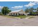 Single-story home with a metal roof and attached garage; street view showing the grassy corner lot at 101 S Cleveland Ave, Fort Meade, FL 33841