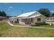 Charming single-story home with well-maintained lawn, screened porch, and white trim at 101 S Cleveland Ave, Fort Meade, FL 33841