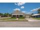 Single-story home with manicured lawn, small walkway, attached garage, and light-colored siding at 101 S Cleveland Ave, Fort Meade, FL 33841