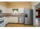 Well-lit kitchen featuring stainless steel appliances, ample cabinetry, and tile flooring at 101 S Cleveland Ave, Fort Meade, FL 33841