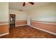 Living room featuring hardwood floors, baseboard trim, and connections to other rooms at 101 S Cleveland Ave, Fort Meade, FL 33841