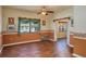 Spacious living room with hardwood floors, decorative molding, ceiling fan, and large windows at 101 S Cleveland Ave, Fort Meade, FL 33841