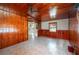 A cozy living room with wood-paneled walls and tile flooring, offering a warm atmosphere at 101 S Cleveland Ave, Fort Meade, FL 33841
