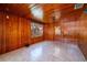 Living room with tile flooring, wood-paneled walls and natural light at 101 S Cleveland Ave, Fort Meade, FL 33841