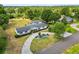 Bird's eye view of a home with well manicured landscaping and an extended driveway at 1205 Rolling Woods Ln, Lakeland, FL 33813