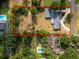 Aerial view of large fenced lot with home and inground pool and lake in the distance at 1205 Rolling Woods Ln, Lakeland, FL 33813