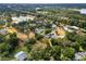 Panoramic aerial shot of a home near a lake and highway access, with greenery at 1205 Rolling Woods Ln, Lakeland, FL 33813