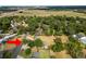 Wide aerial photo of a home in a neighborhood near roads, with mature landscaping at 1205 Rolling Woods Ln, Lakeland, FL 33813