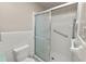 Enclosed shower with sliding glass door, grab bar, and white tile at 1205 Rolling Woods Ln, Lakeland, FL 33813