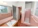 Bathroom with pink tile, a shower, and a wood vanity at 1205 Rolling Woods Ln, Lakeland, FL 33813