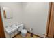 Compact bathroom with toilet, sink, and mirror at 1205 Rolling Woods Ln, Lakeland, FL 33813