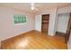 Bedroom features hardwood floors, a window, closet with wood lining, and ceiling fan at 1205 Rolling Woods Ln, Lakeland, FL 33813