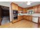 Well-equipped kitchen boasting wood cabinets, modern appliances, laminate flooring, and ample countertop space for cooking at 1205 Rolling Woods Ln, Lakeland, FL 33813