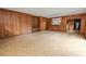 Wood paneled living room with linoleum flooring, built-in shelves, and natural light at 1205 Rolling Woods Ln, Lakeland, FL 33813