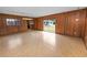 Wood paneled living room with linoleum flooring, sliding glass doors, and a window at 1205 Rolling Woods Ln, Lakeland, FL 33813