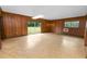 Wood paneled living room with linoleum flooring, sliding glass doors and natural light at 1205 Rolling Woods Ln, Lakeland, FL 33813