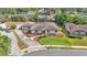 Aerial view of a single-story home with neutral exterior, screened lanai, updated landscaping and ample parking at 1433 Ellison Ln, Lakeland, FL 33801