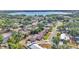 Aerial view of the property showcasing its location near a lake, lush greenery, and residential surroundings at 1433 Ellison Ln, Lakeland, FL 33801