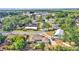 Aerial view of the home nestled among lush trees in a quiet neighborhood, showcasing surrounding greenery at 1433 Ellison Ln, Lakeland, FL 33801
