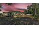 Wide backyard featuring a screened lanai and mature trees at 1433 Ellison Ln, Lakeland, FL 33801