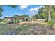 Lush backyard featuring ample space, complemented by mature trees offering shade and privacy at 1433 Ellison Ln, Lakeland, FL 33801
