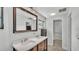 Bright bathroom with double sink vanity, large framed mirror, and tile flooring at 1433 Ellison Ln, Lakeland, FL 33801