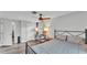 Spacious bedroom with ceiling fan, wood floors, neutral paint, and a view of the interior of the home at 1433 Ellison Ln, Lakeland, FL 33801