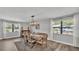 Dining room with wood-look floors, bench seating and modern light fixture at 1433 Ellison Ln, Lakeland, FL 33801